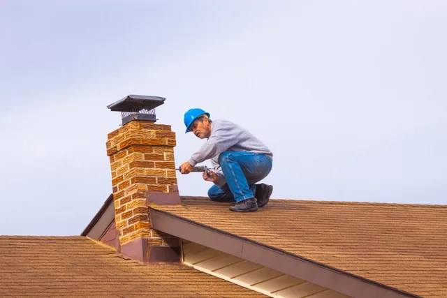 Chimney technician performing rooftop chimney service in Sheboygan, WI